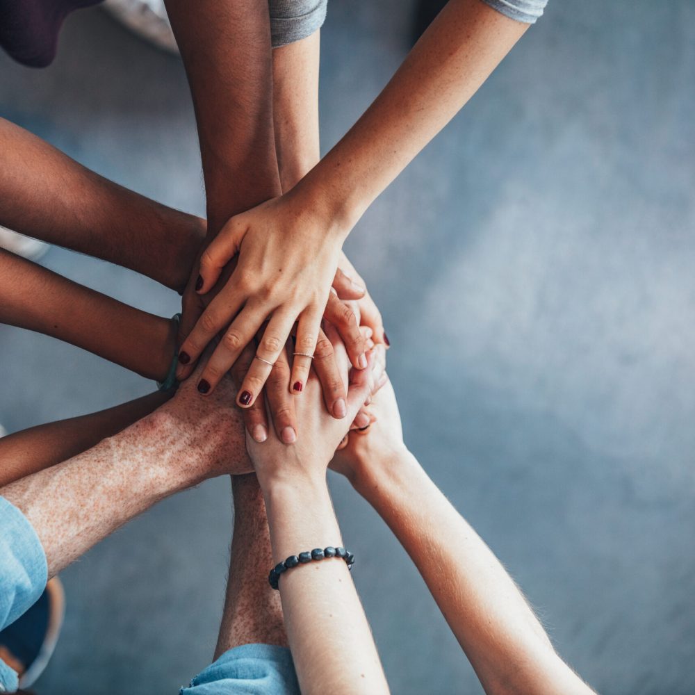 Close,Up,Top,View,Of,Young,People,Putting,Their,Hands